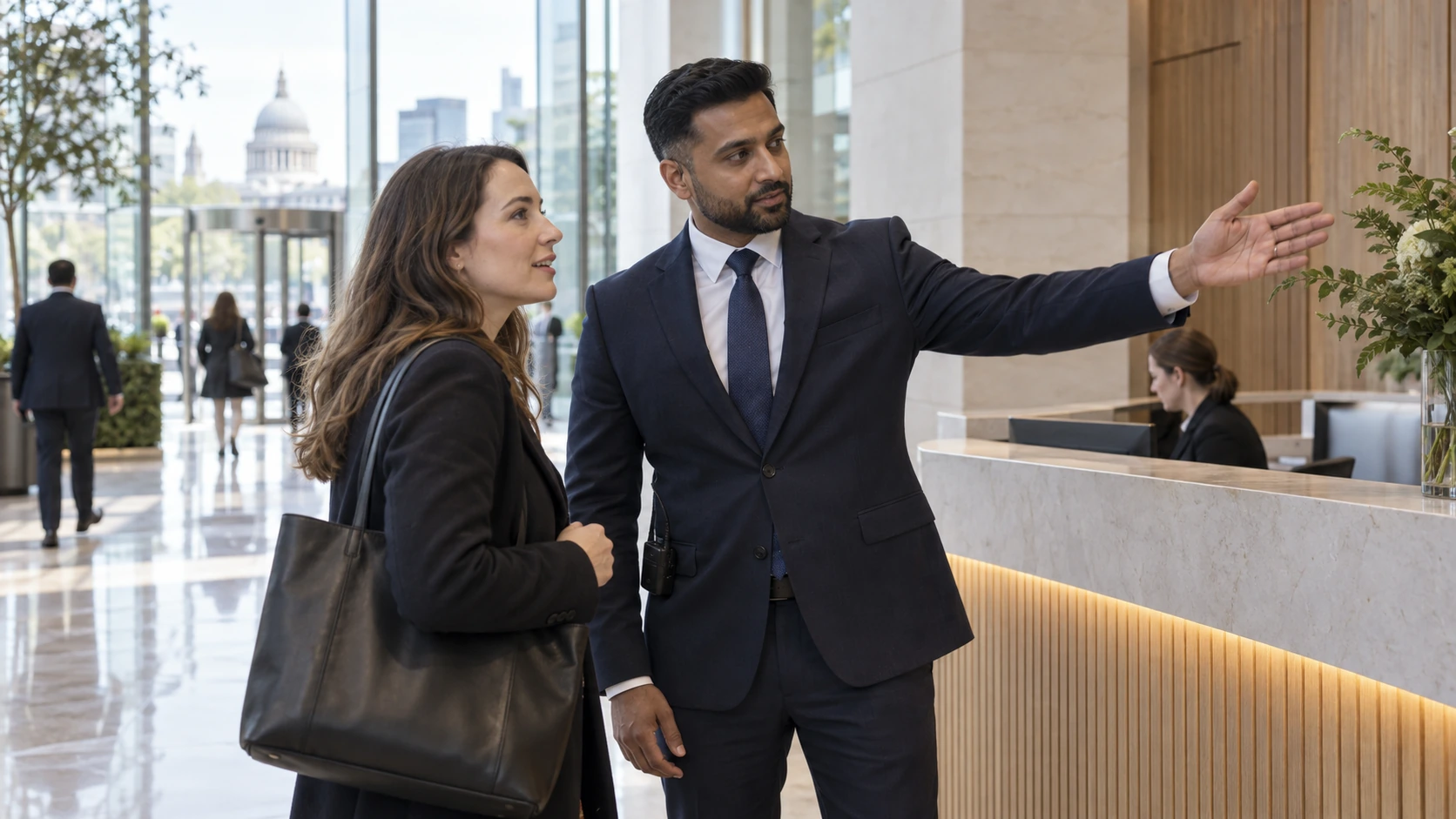 Illustrative security officer assisting a visitor at reception